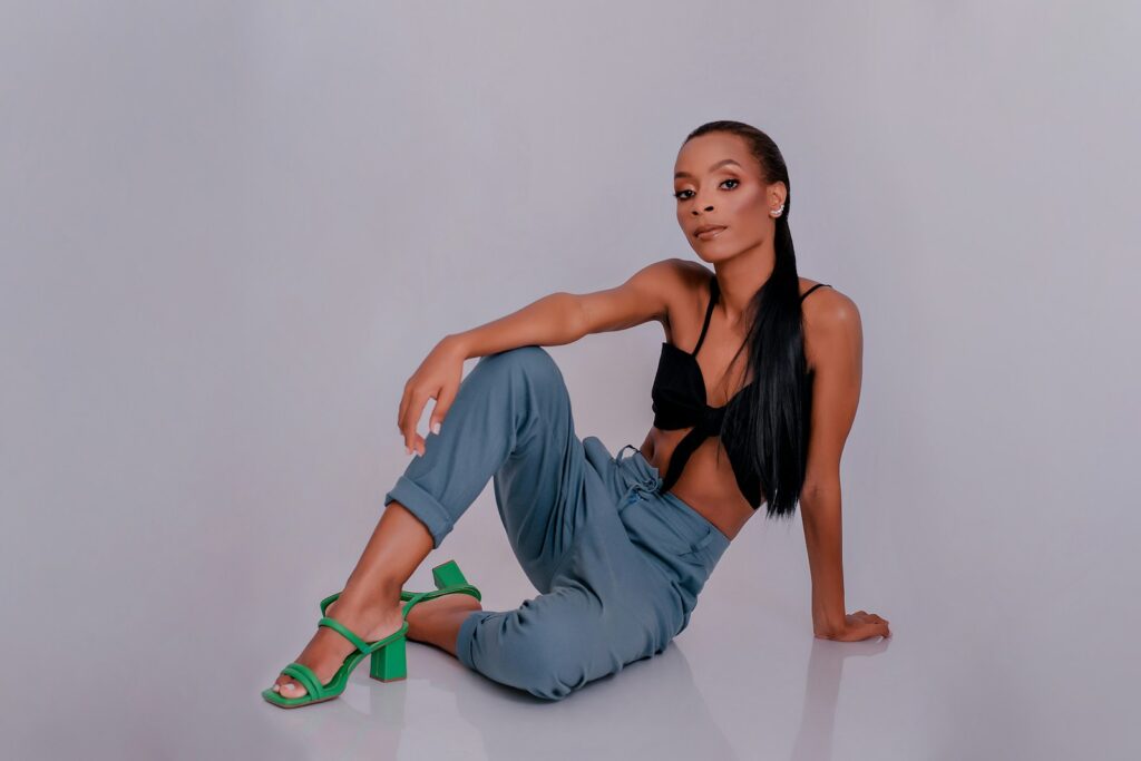 a woman in a black top and blue pants